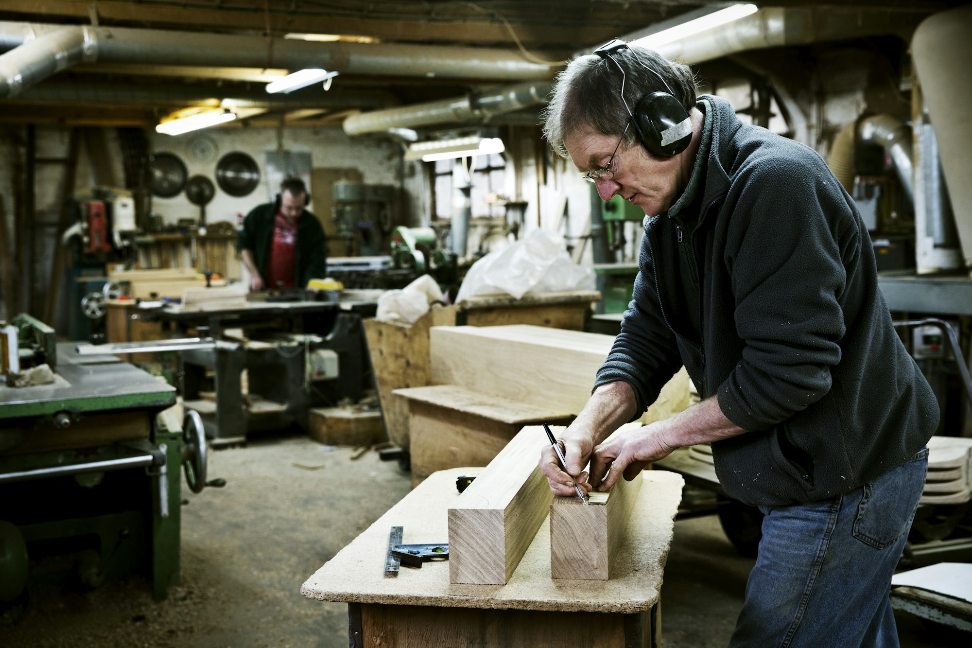 A man working in a furniture maker's workshop.